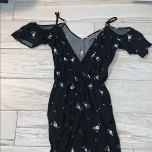 a black floral over the shoulder romper
